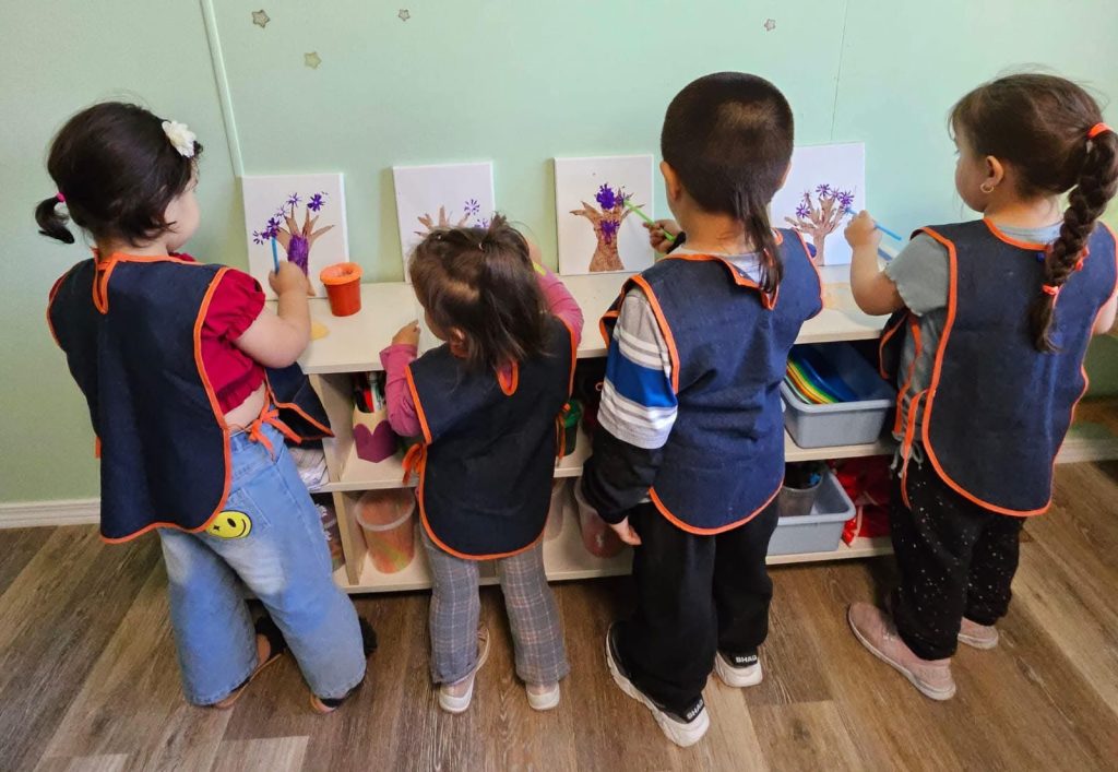 Bellevue preschool children doing art activities on wall boards