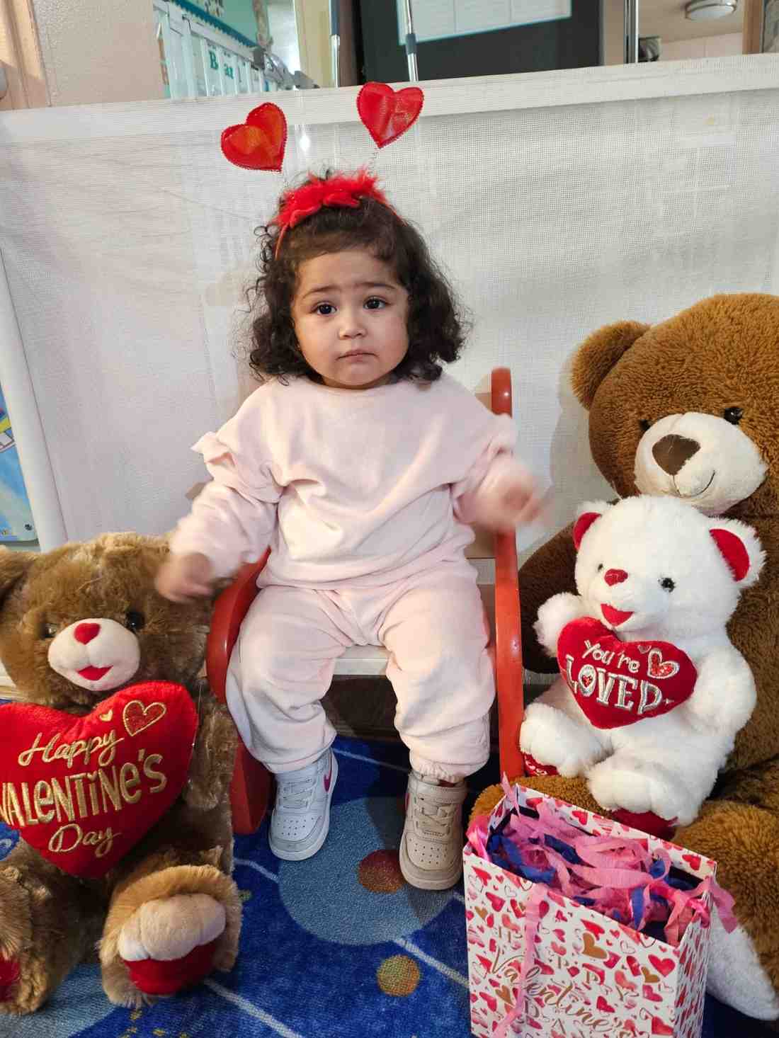 Toddler in Valentine’s setup with teddy bears at Federal Way preschool | early childhood education